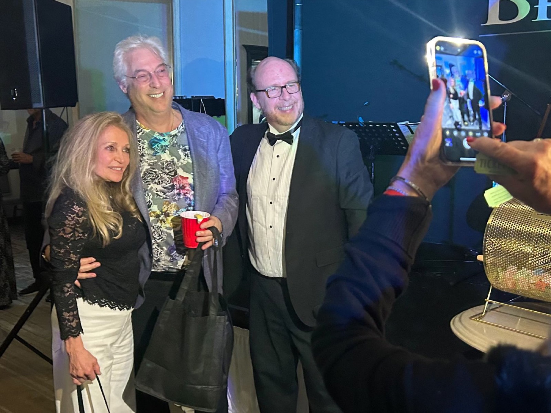 Two guests posing between hands at a corporate casino night