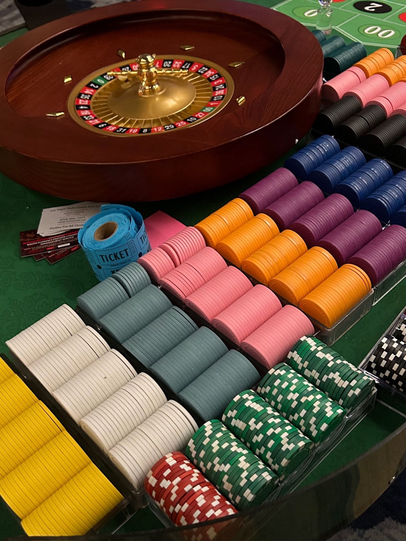 Racks of casino-grade poker chips in multiple colors with raffle tickets