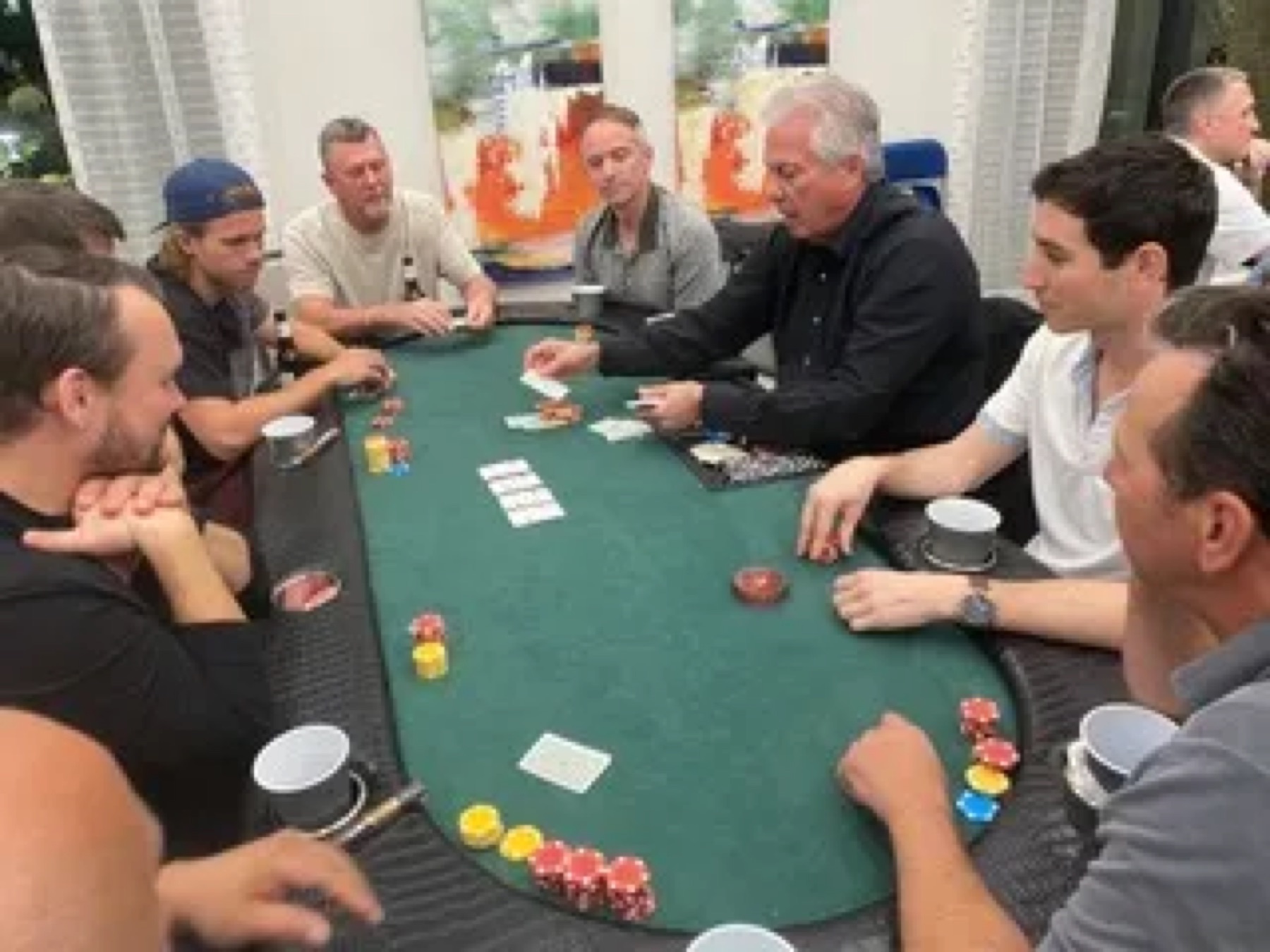 Players at a Texas Hold'em table during a charity poker tournament