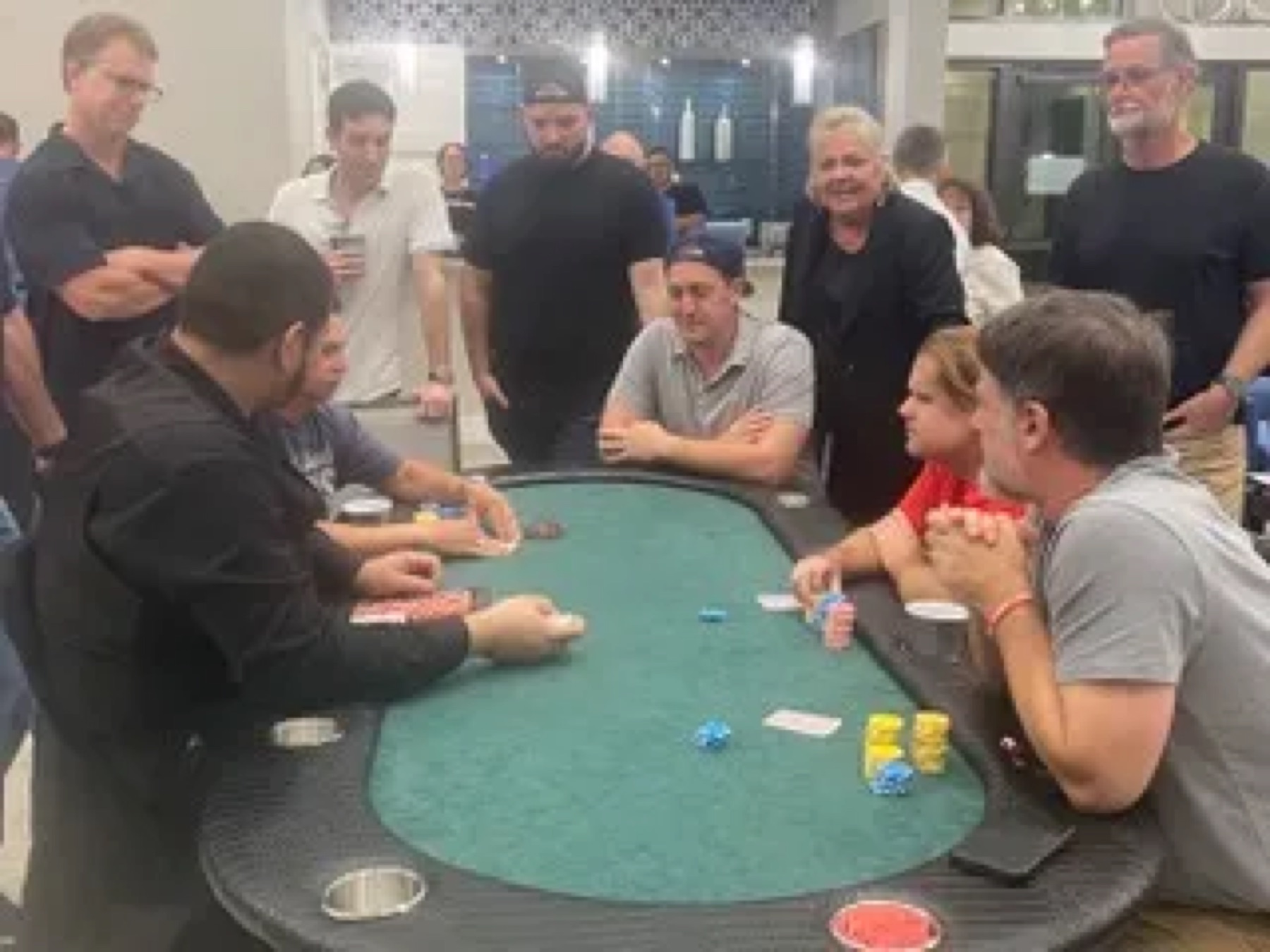 Several poker tables in play at a charity tournament