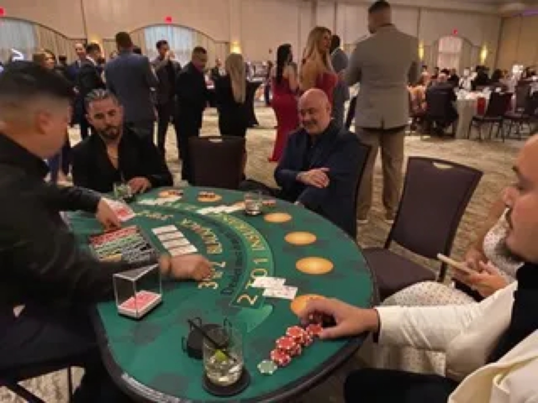 Poker players watching the river card at a tournament table