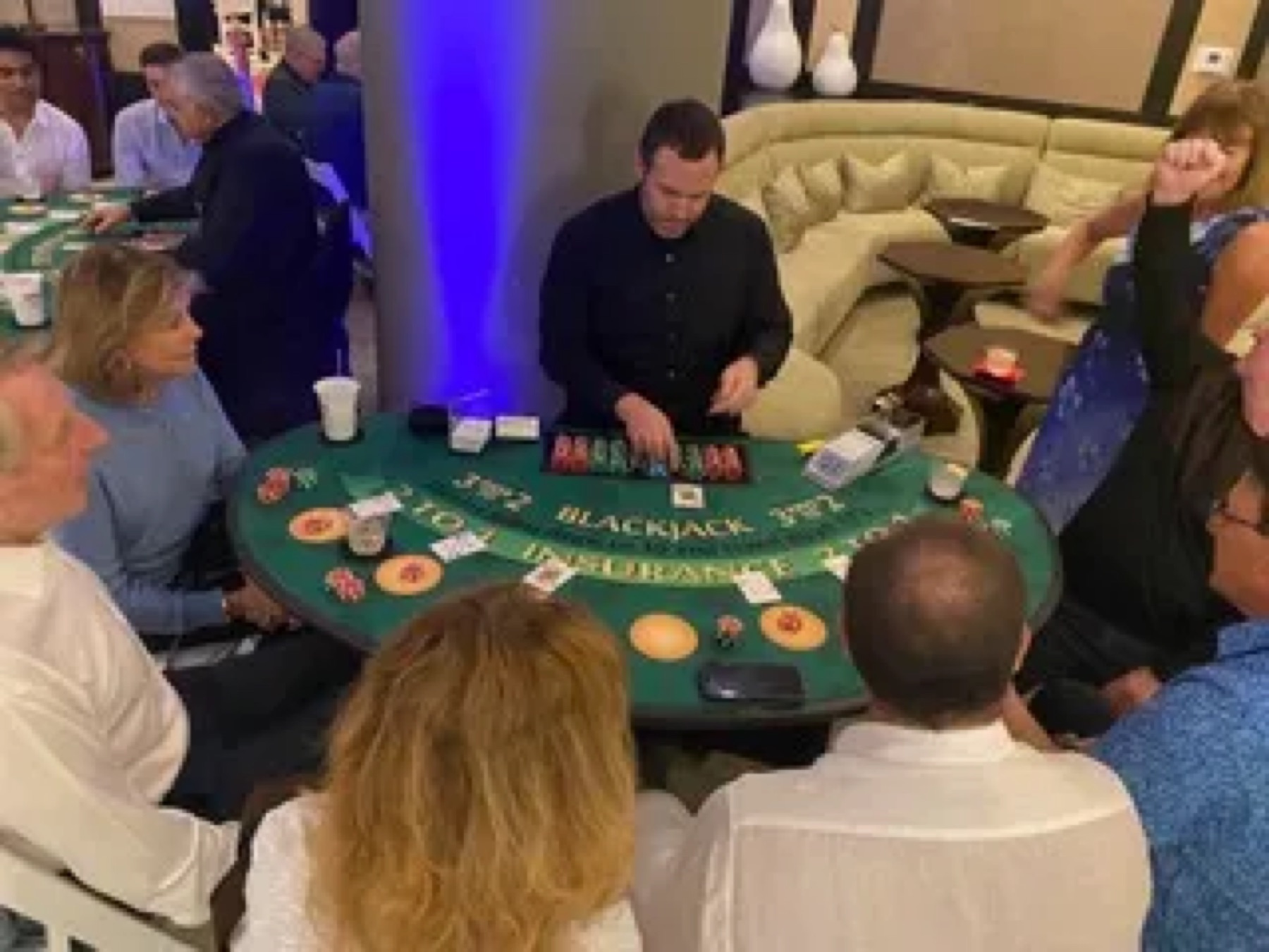Dealer running a blackjack side table at a fundraiser