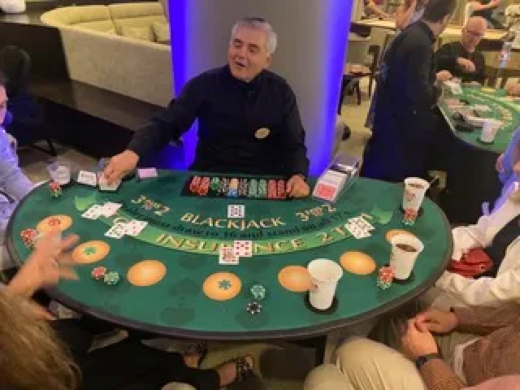 Dealer dealing cards at a blackjack table during a fundraiser